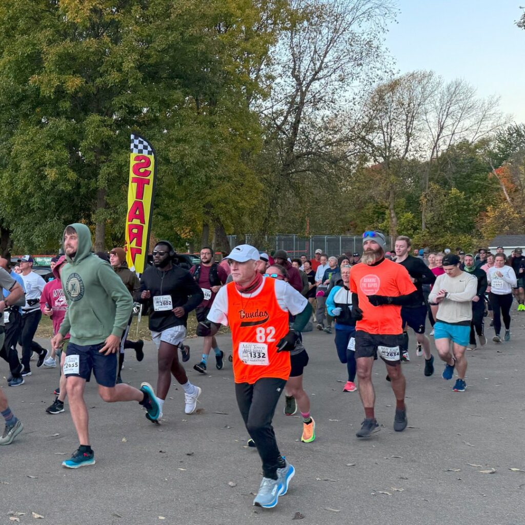 Runners side by side having just started a race at the Mill Town Races series.