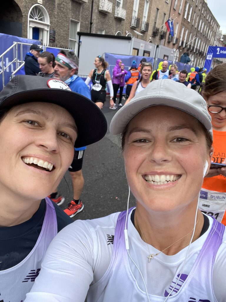 A "selfie" photo of Kate Schriver and Molly Sarhage wearing Project purple singlets as they await the start of the Dublin Marathon